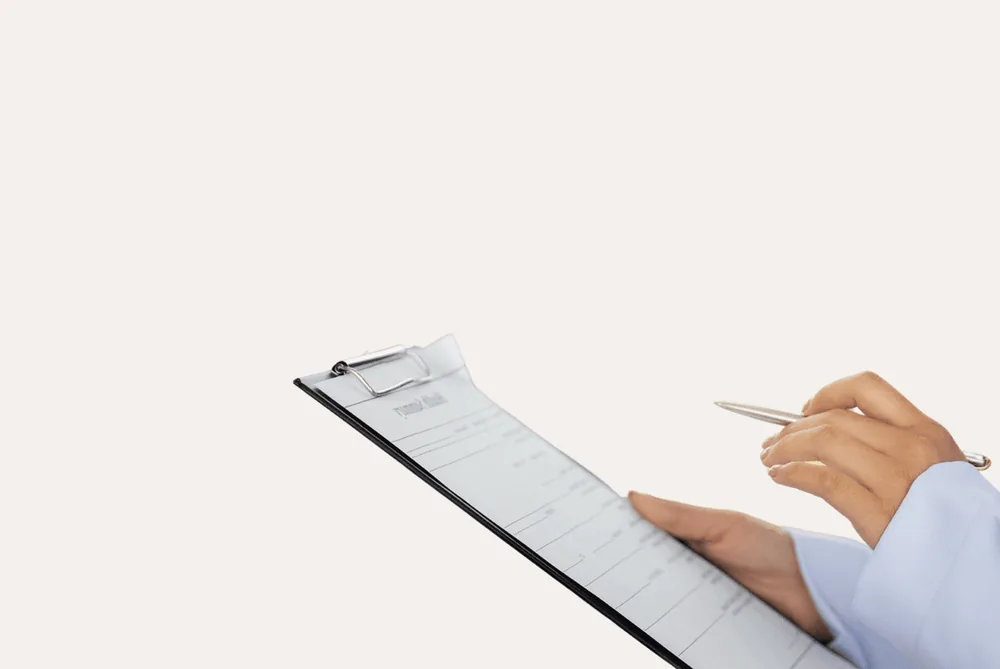A clinician reviewing a patient assessment on a clipboard