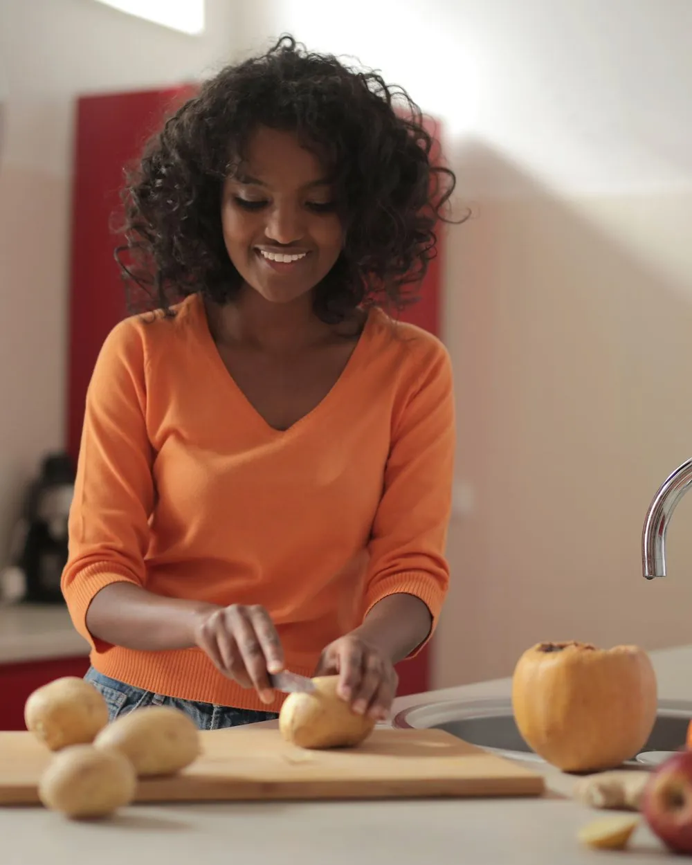 A woman preparing fresh vegetables in her kitchen